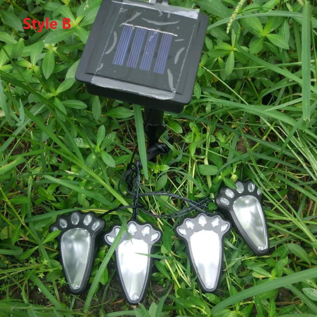 Creative Vault Marketplace solar-powered bear paw garden lights in black plastic with white LED accents on grass