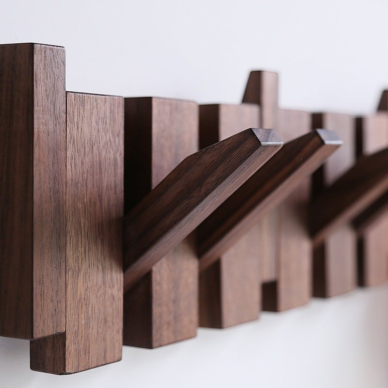 Creative Vault Marketplace piano key-shaped wooden wall coat rack in a dark walnut finish with retractable hooks.