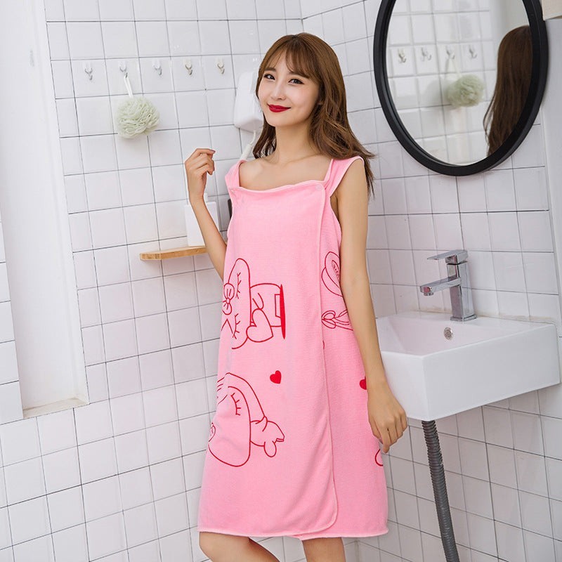Creative Vault Marketplace pink coral fleece cartoon beach towel dress worn by a woman in a bathroom setting