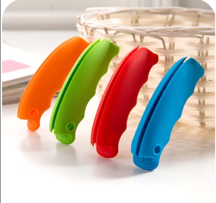 Creative Vault Marketplace silicone grocery bag grips in orange, green, red, and blue for comfortable carrying