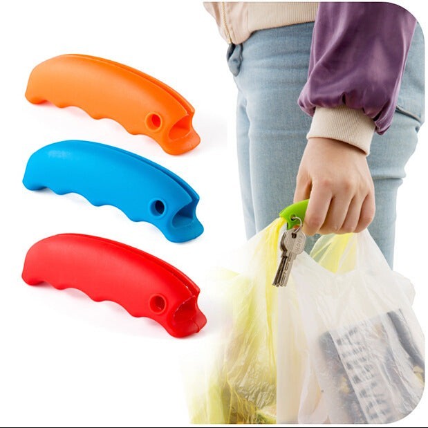 Creative Vault Marketplace silicone grocery bag grips in orange, blue, and red, with a hand using a green grip.