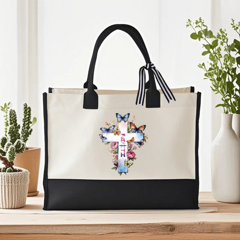 Cream and black cross of faith with butterfly and flower print canvas tote, suitable for church and daily use by Creative Vault Marketplace